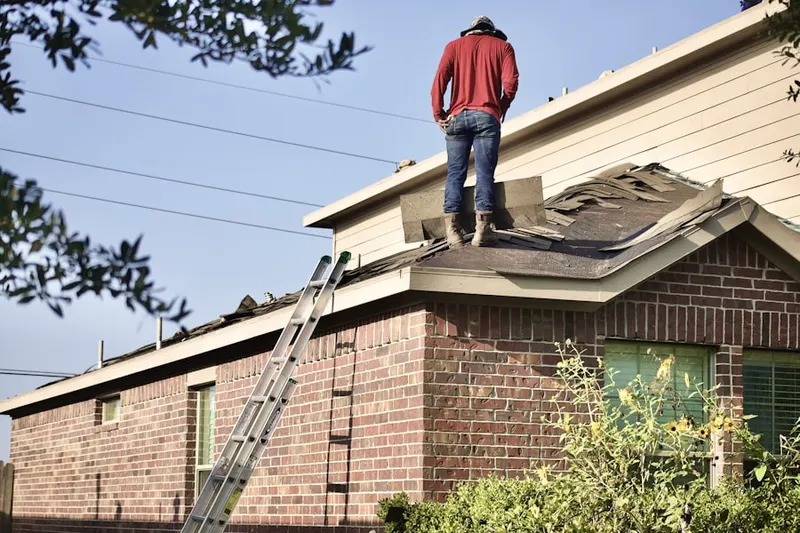 Professional roofer working on a residential roof in Palm Acres